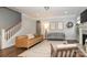 Bright living room with a fireplace, warm wood floors, and two couches under recessed lighting at 136 Morgans Branch Rd, Belmont, NC 28012