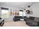 Inviting living room features plush sectional sofa, guitars on the wall, and lots of light at 136 Morgans Branch Rd, Belmont, NC 28012