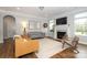 Cozy living room featuring a fireplace, neutral decor, and lots of natural light at 136 Morgans Branch Rd, Belmont, NC 28012