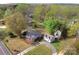 Aerial view of home with a detached garage and a long driveway, surrounded by trees and landscaping at 1460 Legion Club Rd, Salisbury, NC 28146