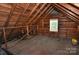 Rustic attic featuring exposed wooden beams, natural light, and ample space for storage at 1460 Legion Club Rd, Salisbury, NC 28146