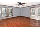 Bedroom with hardwood floors, two windows and French doors leading to the outside at 1460 Legion Club Rd, Salisbury, NC 28146