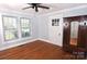 Light-filled bedroom with hardwood floors, ceiling fan, and a built-in armoire at 1460 Legion Club Rd, Salisbury, NC 28146
