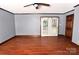 Spacious bedroom with hardwood floors, ceiling fan, and exterior French doors at 1460 Legion Club Rd, Salisbury, NC 28146