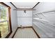 Walk-in closet with white wire shelving and hardwood trim around the window at 1460 Legion Club Rd, Salisbury, NC 28146