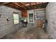 Interior view of a block-wall garage with two windows, overhead storage, and concrete floor at 1460 Legion Club Rd, Salisbury, NC 28146