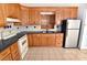 Traditional-style kitchen featuring wood cabinets, granite counters and stainless steel refrigerator at 1460 Legion Club Rd, Salisbury, NC 28146