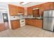 Traditional-style kitchen featuring wood cabinets, tile backsplash and stainless steel refrigerator at 1460 Legion Club Rd, Salisbury, NC 28146