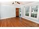 Cozy living room with hardwood floors, light blue walls, and a wooden front door at 1460 Legion Club Rd, Salisbury, NC 28146