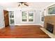 Inviting living room with hardwood floors, brick fireplace, and sunlit windows at 1460 Legion Club Rd, Salisbury, NC 28146