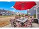 Backyard patio featuring an outdoor table and chair set with a large red umbrella at 14921 Baldridge Dr, Huntersville, NC 28078