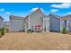 Wide shot of the backyard and back of the house featuring a patio and a short fence row at 14921 Baldridge Dr, Huntersville, NC 28078