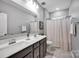 Bathroom with dual vanity, hard surface counters, and tub/shower combination at 14921 Baldridge Dr, Huntersville, NC 28078