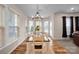 Bright dining room with a bay window, a chandelier, and wood flooring at 14921 Baldridge Dr, Huntersville, NC 28078