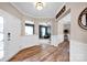 Open foyer featuring hardwood floors, neutral paint, and an entryway to the living space at 14921 Baldridge Dr, Huntersville, NC 28078