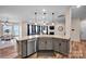 A kitchen island features granite countertops, stainless appliances, and opens to the living room at 14921 Baldridge Dr, Huntersville, NC 28078