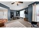 Comfortable living room with blue walls, neutral carpet, bright windows, and stylish decor at 14921 Baldridge Dr, Huntersville, NC 28078