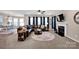 Spacious living room featuring plush carpeting, a modern fireplace, and large windows for natural light at 14921 Baldridge Dr, Huntersville, NC 28078