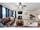 Cozy living room featuring neutral walls, a modern fireplace, and large windows for natural light at 14921 Baldridge Dr, Huntersville, NC 28078