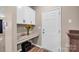 Functional mudroom features a built-in desk, a cabinet, granite countertops, and a storage cubby at 14921 Baldridge Dr, Huntersville, NC 28078