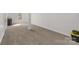 Finished basement with neutral carpet, natural light and a support beam and storage container at 1527 Meadow Glen Ln, Rock Hill, SC 29730
