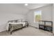 Bright bedroom featuring a black daybed with white bedding and a shelf, next to a sunlit window at 1527 Meadow Glen Ln, Rock Hill, SC 29730