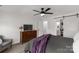 Spacious bedroom with a ceiling fan, dresser, and sliding barn door leading to the ensuite bathroom at 1527 Meadow Glen Ln, Rock Hill, SC 29730