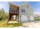 Back exterior view featuring a screened porch, two-car garage, and backyard area with potential at 1527 Meadow Glen Ln, Rock Hill, SC 29730