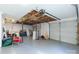 Spacious garage featuring an exposed ceiling, two garage doors and storage space at 1527 Meadow Glen Ln, Rock Hill, SC 29730