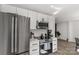 Modern kitchen with stainless steel appliances, white cabinets, and a view into the dining area at 1527 Meadow Glen Ln, Rock Hill, SC 29730