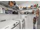 Functional laundry room with modern washer and dryer and ample shelving for storage at 1527 Meadow Glen Ln, Rock Hill, SC 29730