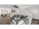 Spacious living room featuring an expansive sectional sofa, modern decor, and seamless flow to the dining area at 1527 Meadow Glen Ln, Rock Hill, SC 29730