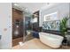 Modern bathroom featuring a soaking tub, glass shower, and sleek tile work at 1754 Brawley School Rd, Mooresville, NC 28117