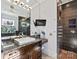 Bathroom features a granite countertop, shower with detailed tile and a mounted TV at 1754 Brawley School Rd, Mooresville, NC 28117