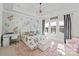 Bedroom featuring floral wallpaper, a decorative light fixture, and a desk space at 1754 Brawley School Rd, Mooresville, NC 28117