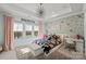 Cozy bedroom with tray ceiling, a star chandelier and floral accent wall at 1754 Brawley School Rd, Mooresville, NC 28117