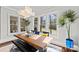 Bright dining area with large windows, modern lighting, and a view of the yard at 1754 Brawley School Rd, Mooresville, NC 28117