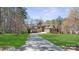 Charming home with well-manicured lawn, beautiful mature trees, and an inviting circular driveway at 1754 Brawley School Rd, Mooresville, NC 28117