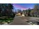 Stately home with a long driveway and 2 car garage surrounded by manicured landscaping at 1754 Brawley School Rd, Mooresville, NC 28117