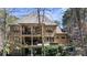 Multi-level back exterior featuring a tiered deck and balcony overlooking lush greenery at 1754 Brawley School Rd, Mooresville, NC 28117