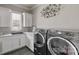 Bright laundry room with modern appliances, granite countertops, and ample storage at 1754 Brawley School Rd, Mooresville, NC 28117