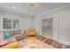 Bright living room featuring a plush sofa, a colorful rug, and natural light at 1754 Brawley School Rd, Mooresville, NC 28117