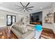 Open-concept living room with fireplace, modern furnishings, and staircase access at 1754 Brawley School Rd, Mooresville, NC 28117