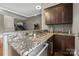 Contemporary wet bar with granite countertop and appliances in recreation room at 1754 Brawley School Rd, Mooresville, NC 28117