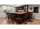 Stylish home bar with leather-seated stools, granite countertops, and custom cabinetry, perfect for entertaining guests at 200 Highland Forest Dr, Charlotte, NC 28270