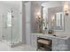 Chic bathroom boasts glass enclosed shower, vanity area with a comfortable seat, and stylish decorative accents at 200 Highland Forest Dr, Charlotte, NC 28270