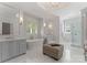 Bright bathroom with marble floors, dual vanities, a freestanding tub, and a glass-enclosed shower at 200 Highland Forest Dr, Charlotte, NC 28270