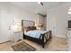 Well-lit bedroom with a decorative rug, neutral color scheme, tiled floors, and ensuite wet bar at 200 Highland Forest Dr, Charlotte, NC 28270