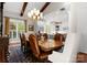 Elegant dining room features wooden beams, large windows, and a decorative chandelier over a beautiful wood table at 200 Highland Forest Dr, Charlotte, NC 28270
