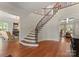 Grand foyer showcases a curved staircase with wrought iron railing and hardwood floors at 200 Highland Forest Dr, Charlotte, NC 28270